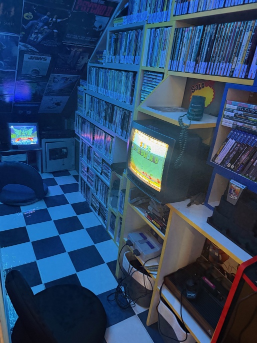 play video games and watch movies in this 80s and 90s retro video store game room